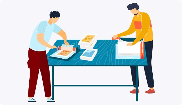 two guys are folding papers